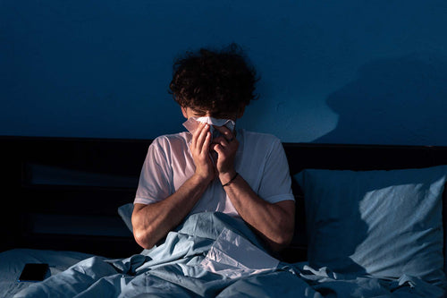 A person suffering from nighttime allergies
