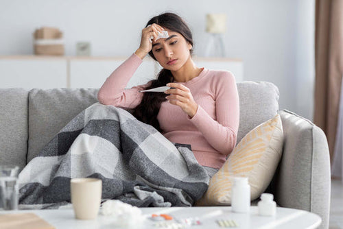 A woman checking if fever is caused by allergies