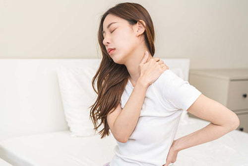 A woman experiencing body aches due to allergies