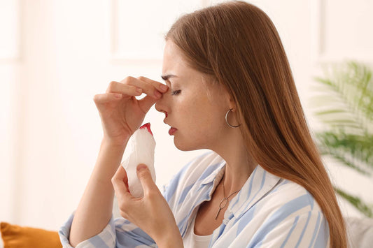 A woman having nosebleeds from allergies