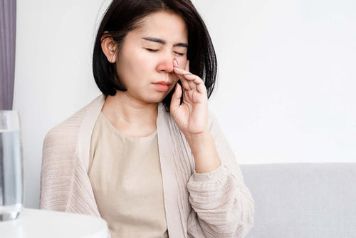 A woman suffering from nasal congestion