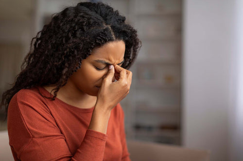A woman suffering from sinus pressure