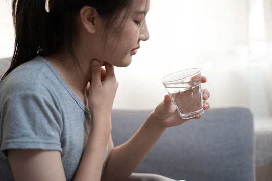 A woman suffering from itchy throat cough